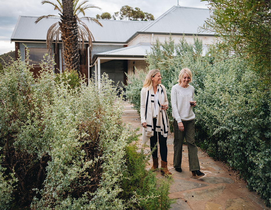 Friends walking around Arkaba Homestead, tasting red wine.